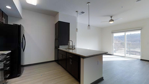 an empty kitchen with a refrigerator and a sink