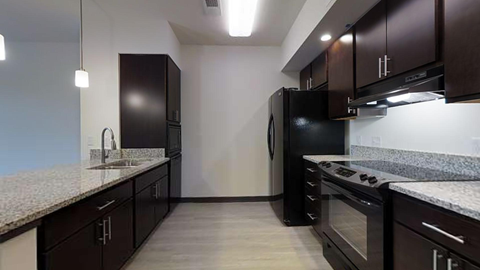 a kitchen with black appliances and granite counter tops