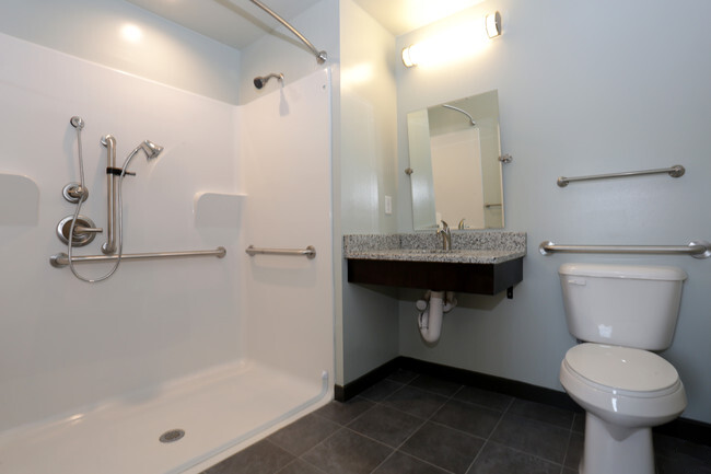 a bathroom with a toilet and a sink and a shower