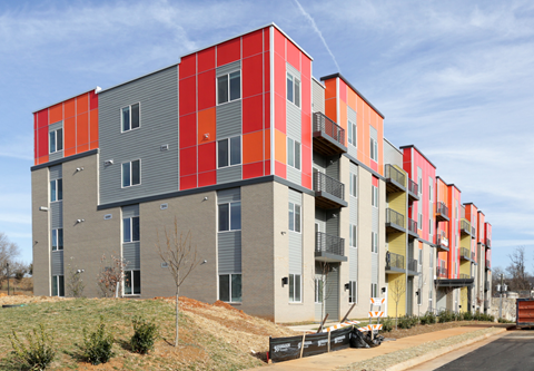 a view of a row of houses with different colored roofs