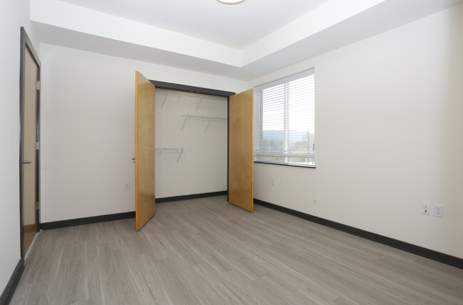 an empty room with a window and a door