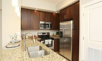 a kitchen with stainless steel appliances and granite counter tops