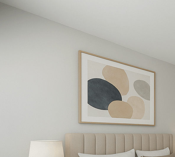 A bedroom with a large bed and a painting on the wall.