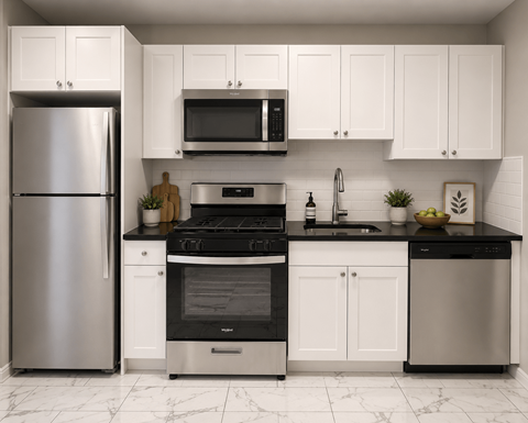 A modern kitchen with a stainless steel refrigerator, black countertops, and white cabinets.