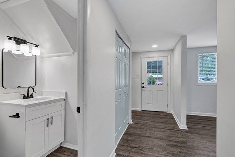 A bathroom with a white sink and a mirror.