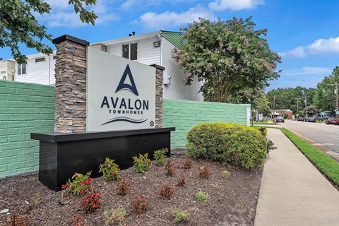 Avalon Townhomes sign in front of a building.
