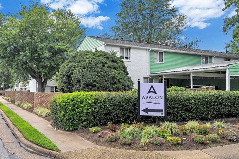 A sign in front of a building that says Avalon.