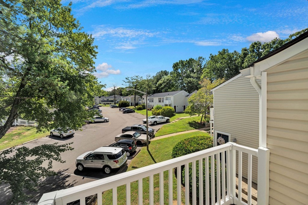 a balcony with a view of a parking lot with cars