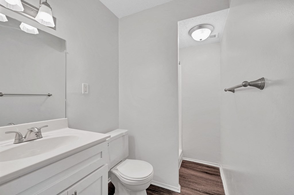 an empty bathroom with a white sink and toilet