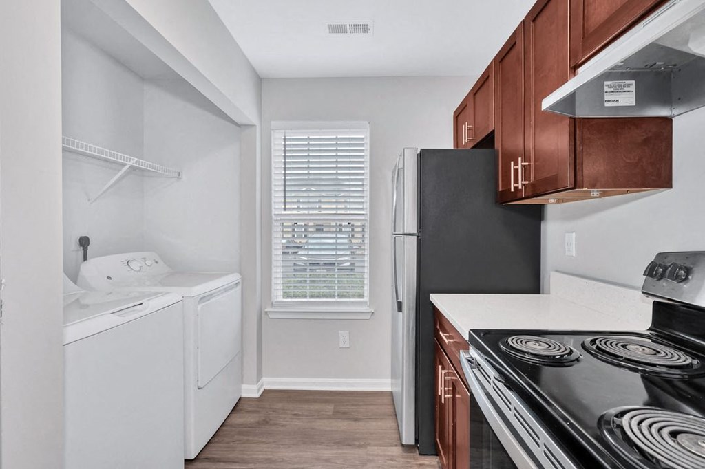 a kitchen with white appliances and wooden cabinets