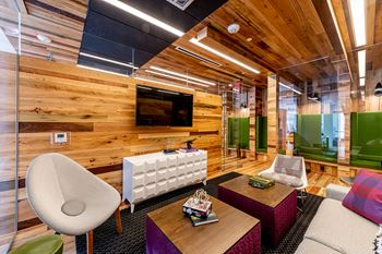 a room with a wooden wall and purple and white furniture