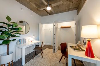 a room with two desks and a mirror