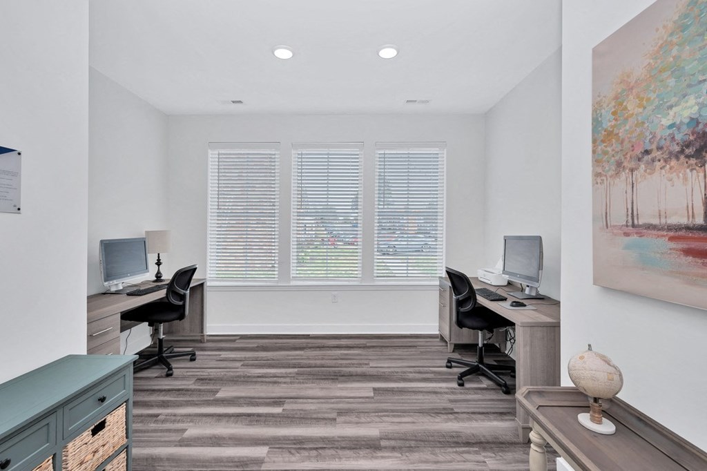 a room with two desks and two computer monitors