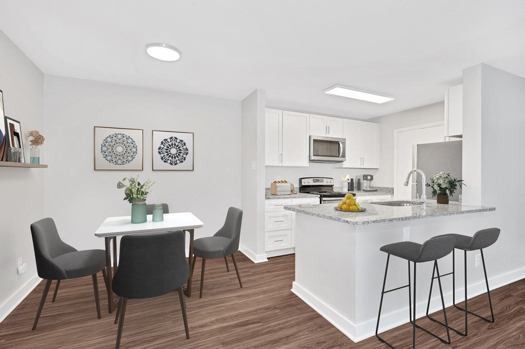 an open kitchen and dining area with a table and chairs