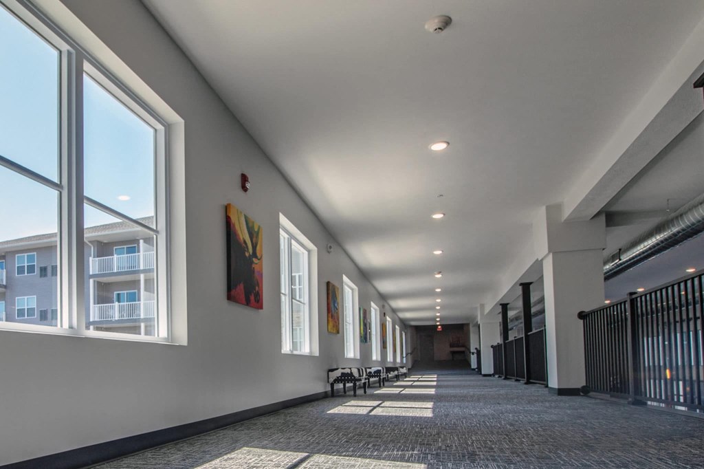 a long hallway with large windows in a building