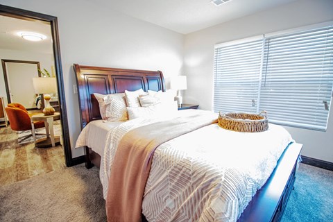 a bedroom with a large bed and a large window