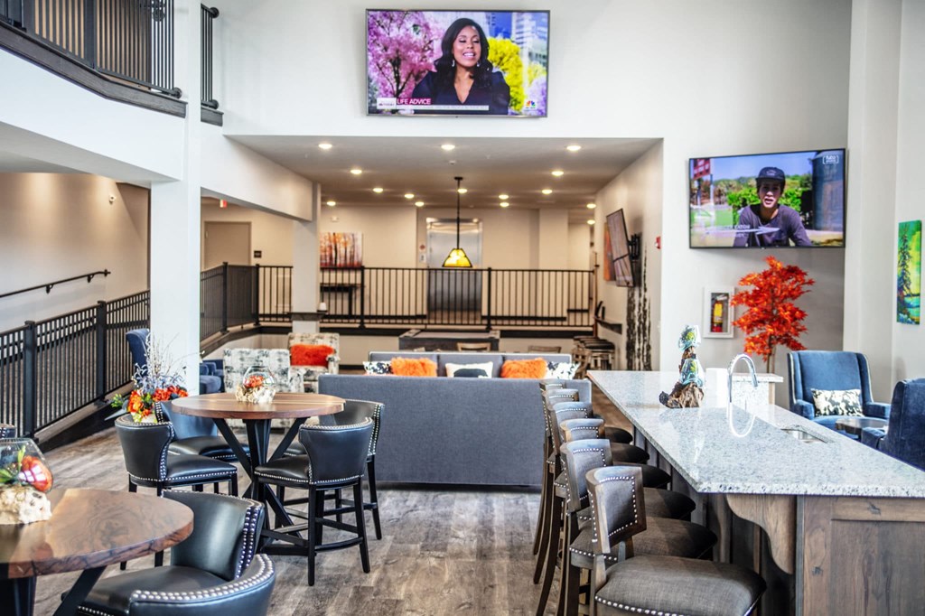 a restaurant with tables and chairs and a lobby with televisions