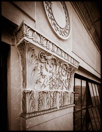 an ornate pillar on the side of a building
