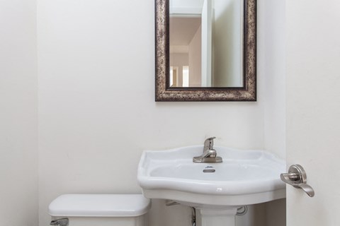 a small bathroom with a sink and a mirror