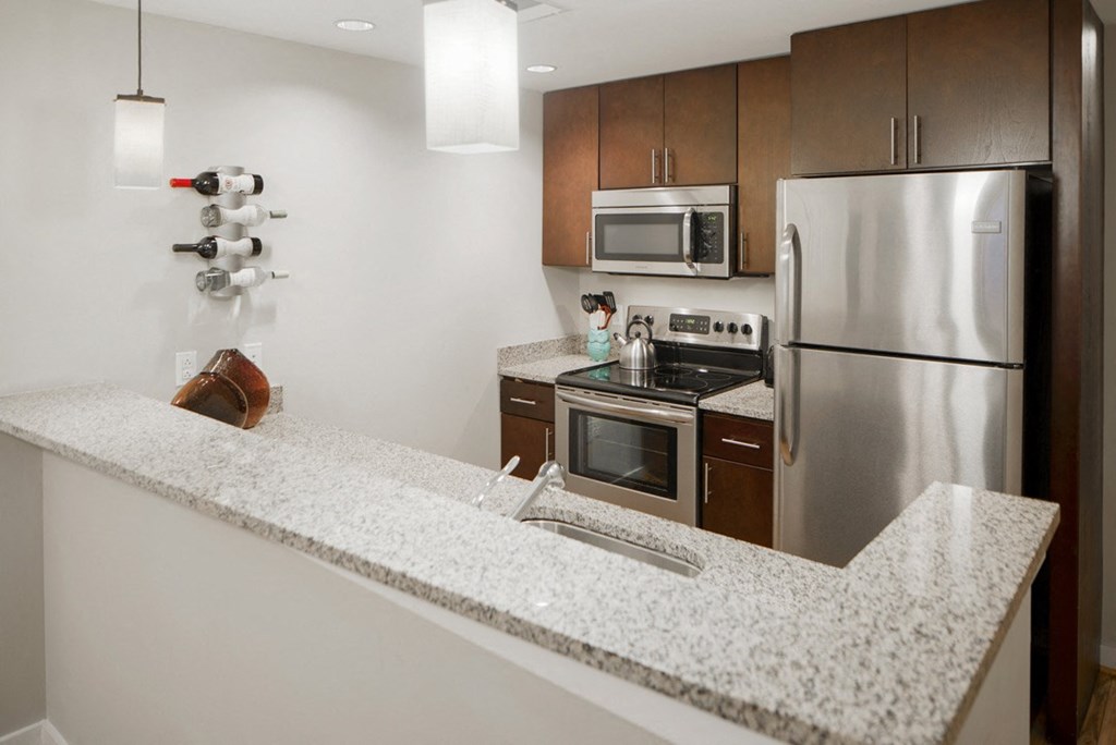 a kitchen with granite counter tops and stainless steel appliances