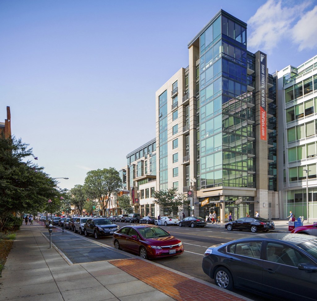 a view of a city street with cars and buildings