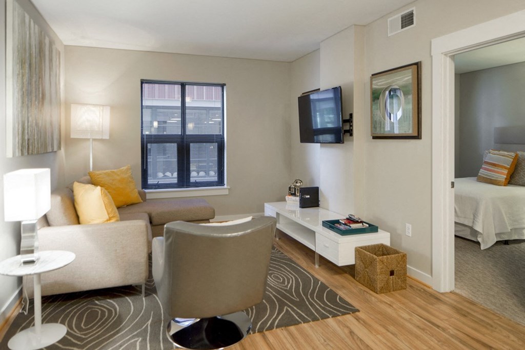 a living room with a couch and a chair and a television