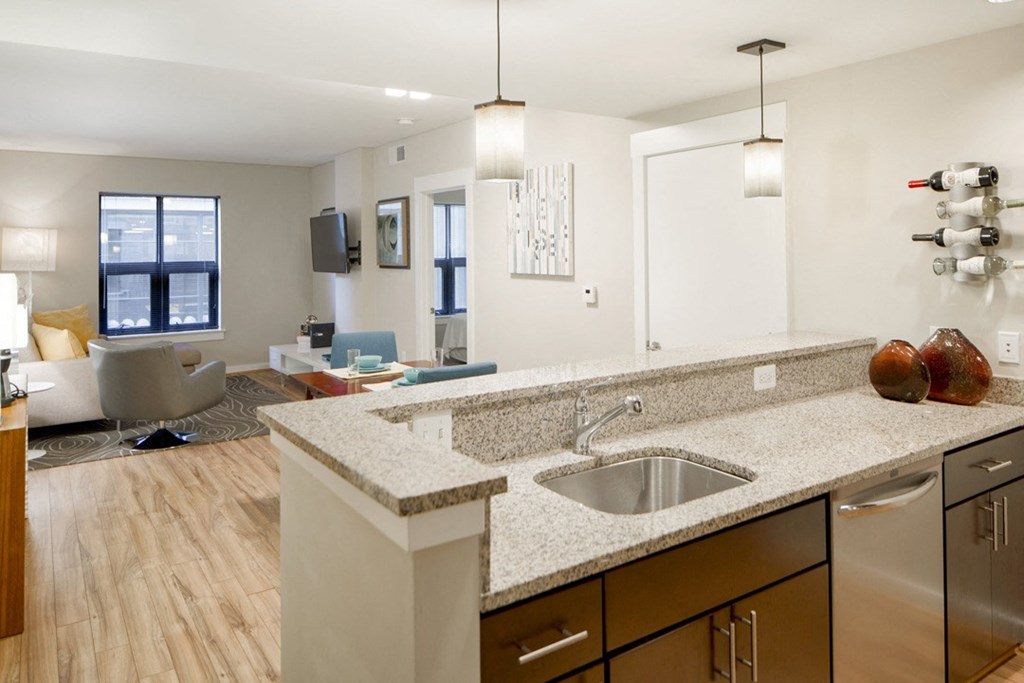 a kitchen with a sink and a view of a living room
