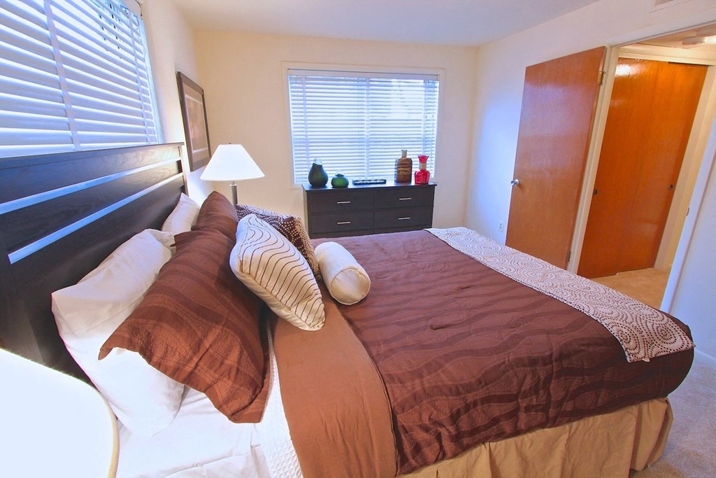 a bedroom with a bed and a window