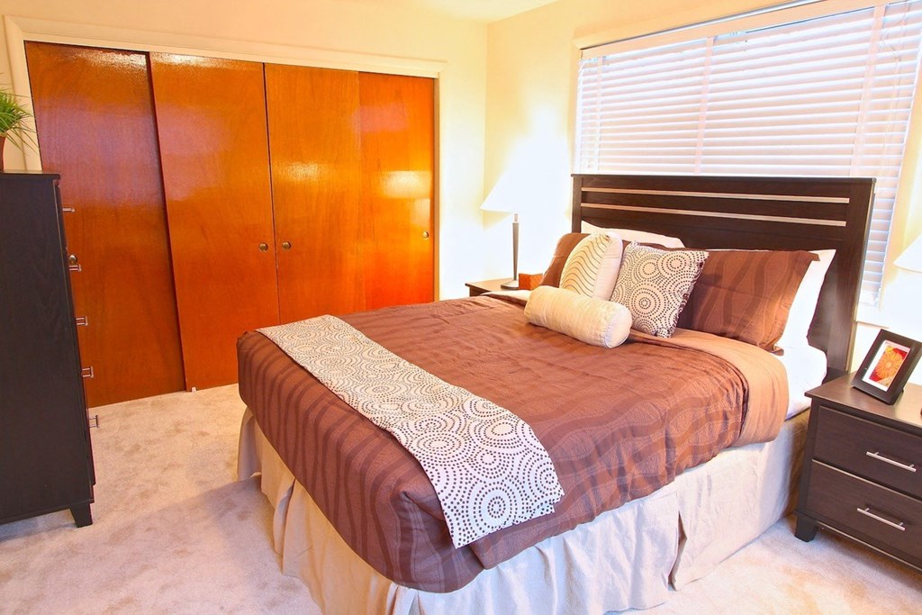 a bedroom with a bed and two closets