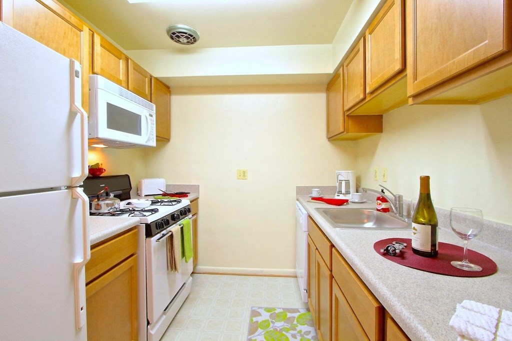 a kitchen with wooden cabinets and white appliances