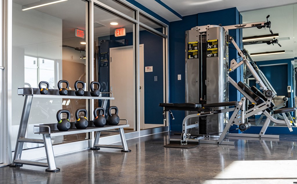 a fitness room with weights and a gym machine