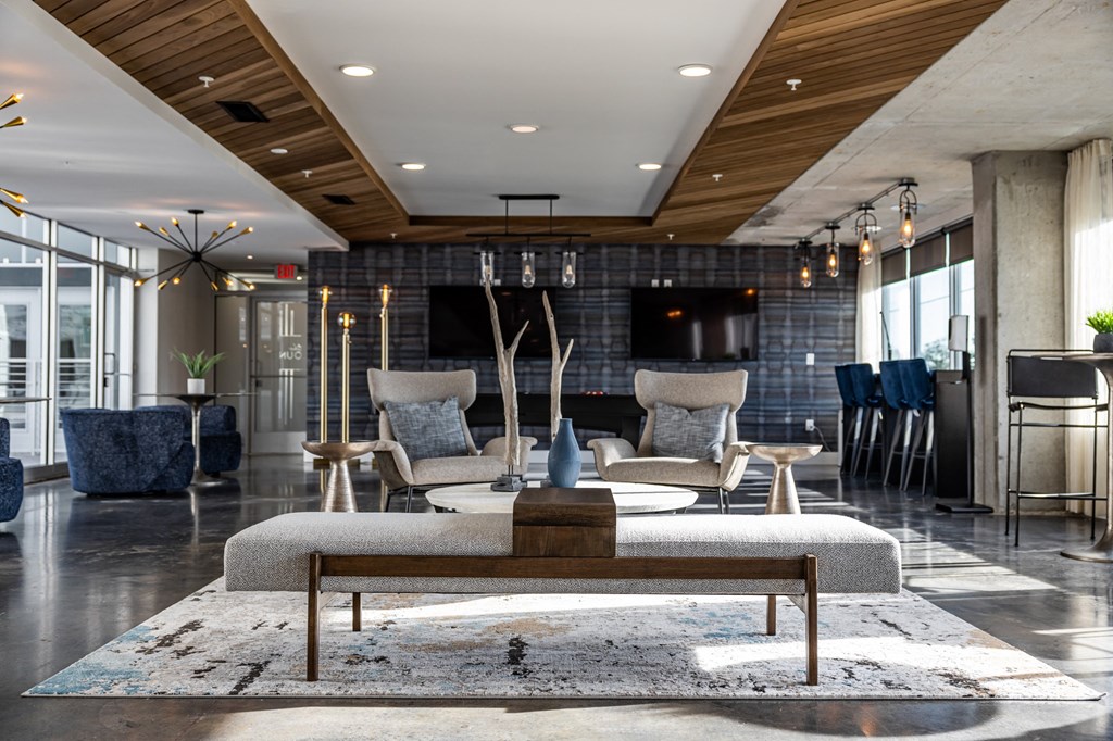 a living room with a couch and chairs and a table