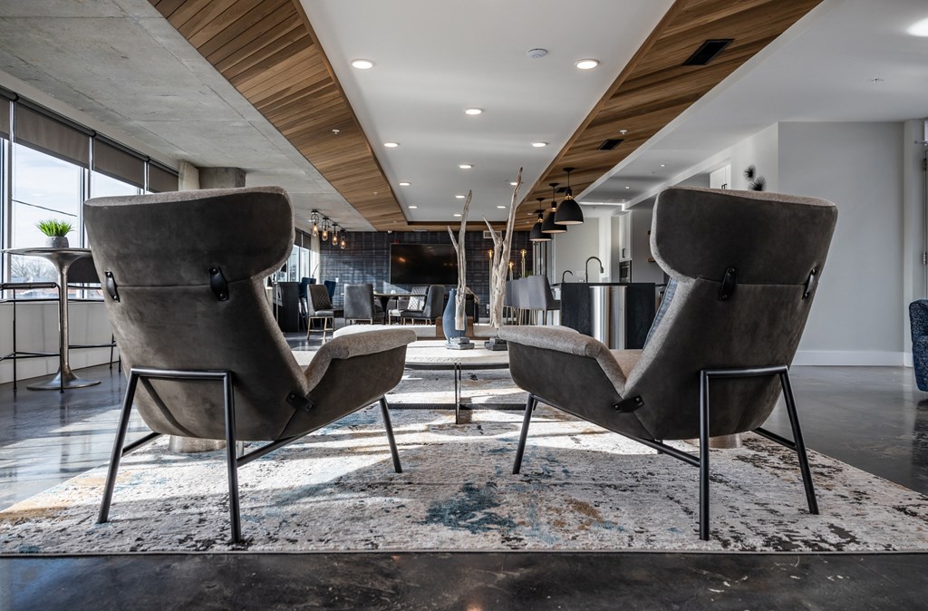 two chairs on a rug in a lobby of a building