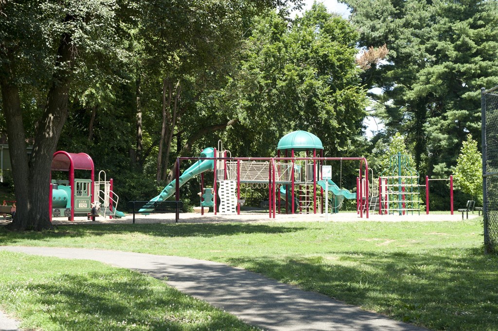 a childrens park with a playground and slides