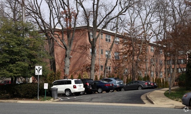 a large brick building with a parking lot in front of it