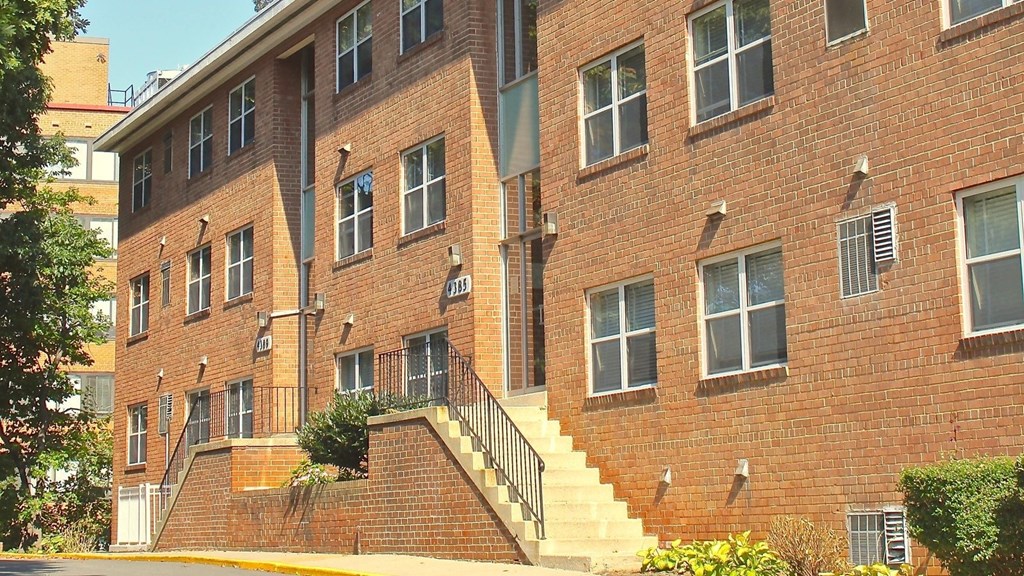 a large brick building with a staircase in front of it