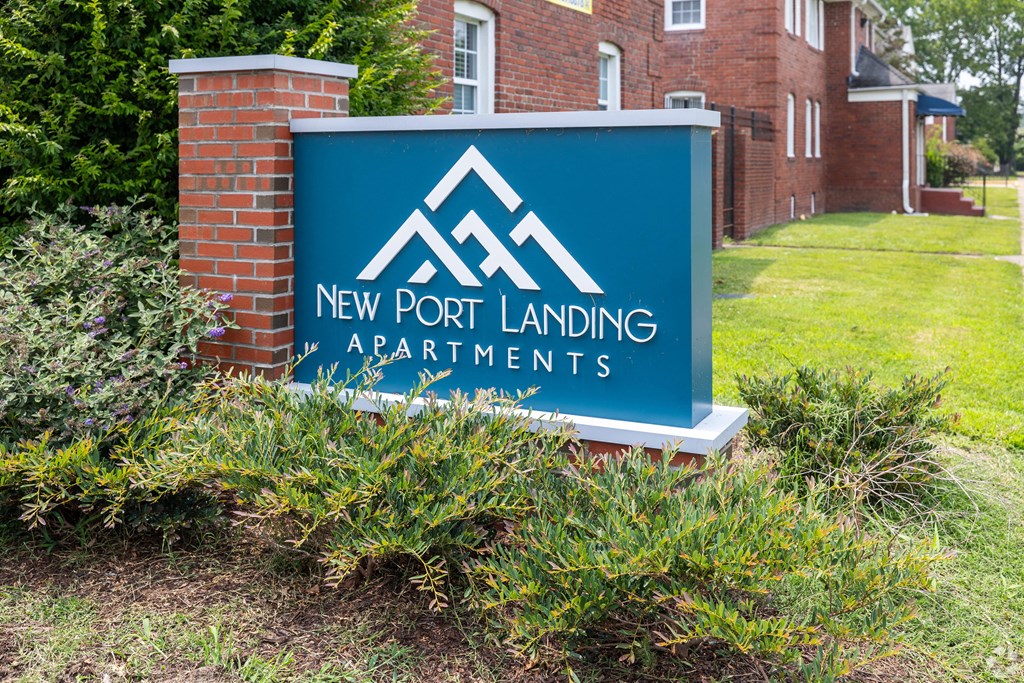 a sign landing apartments in front of a building