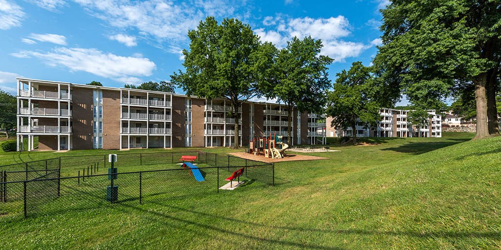 a dog park in front of an apartment building