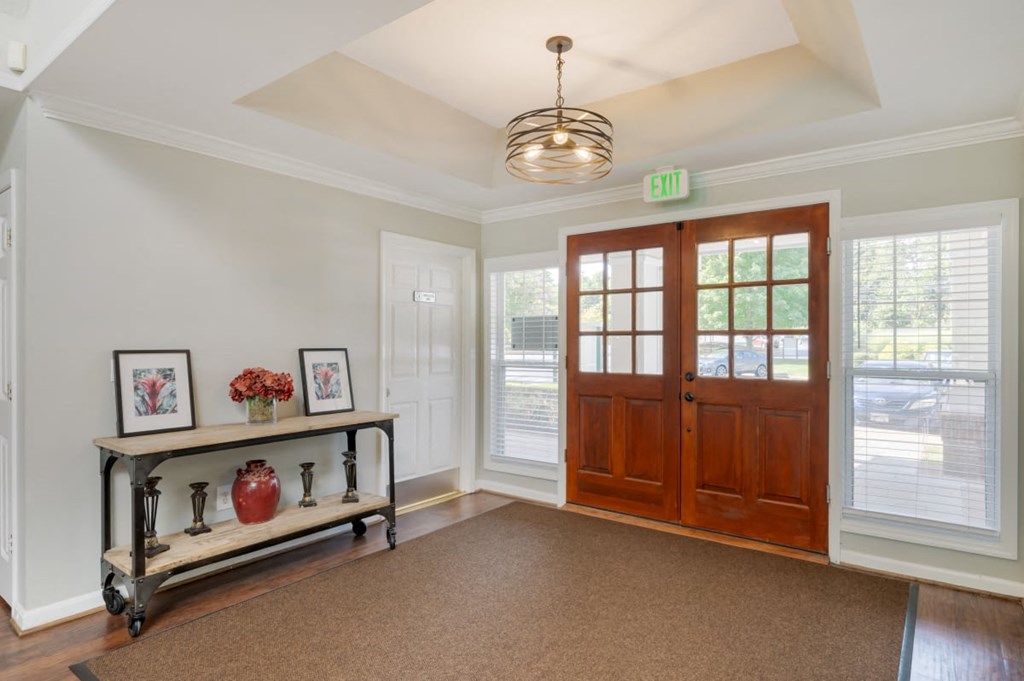 the entryway of a house with a wooden door and a window