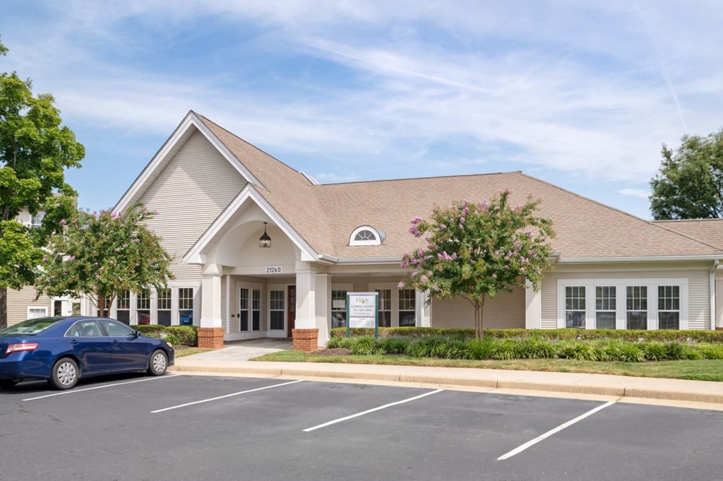 a building with a parking lot and a car in front of it