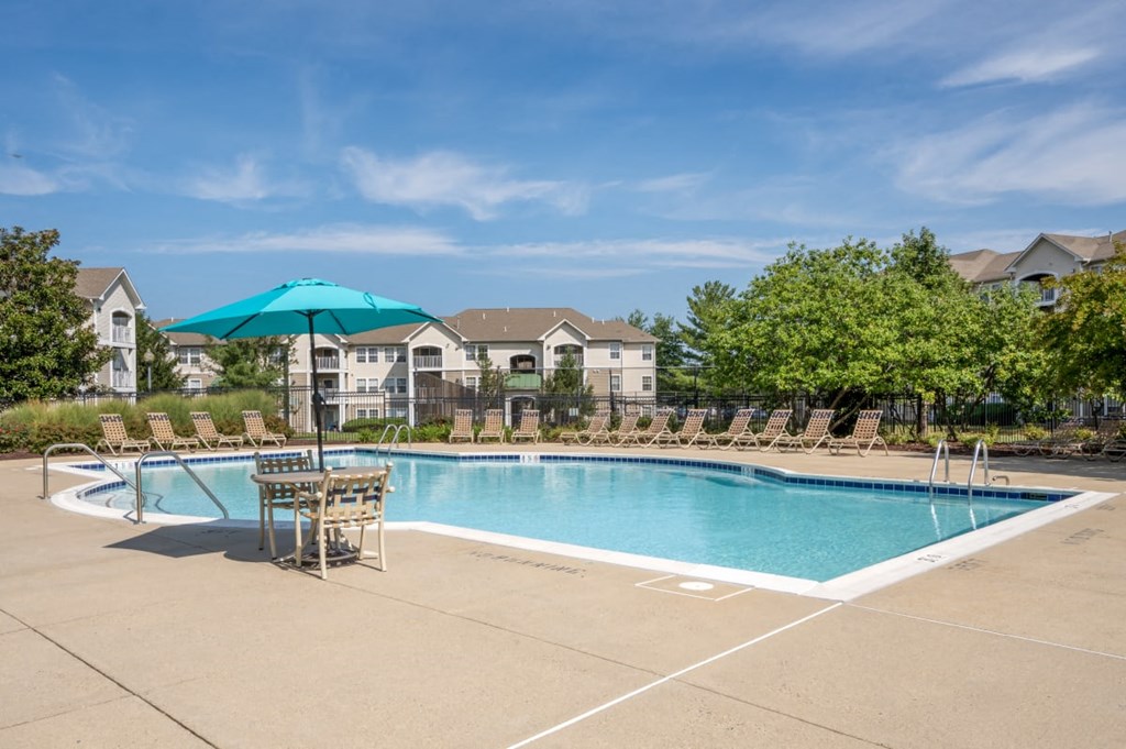 our apartments have a swimming pool with chairs and umbrellas