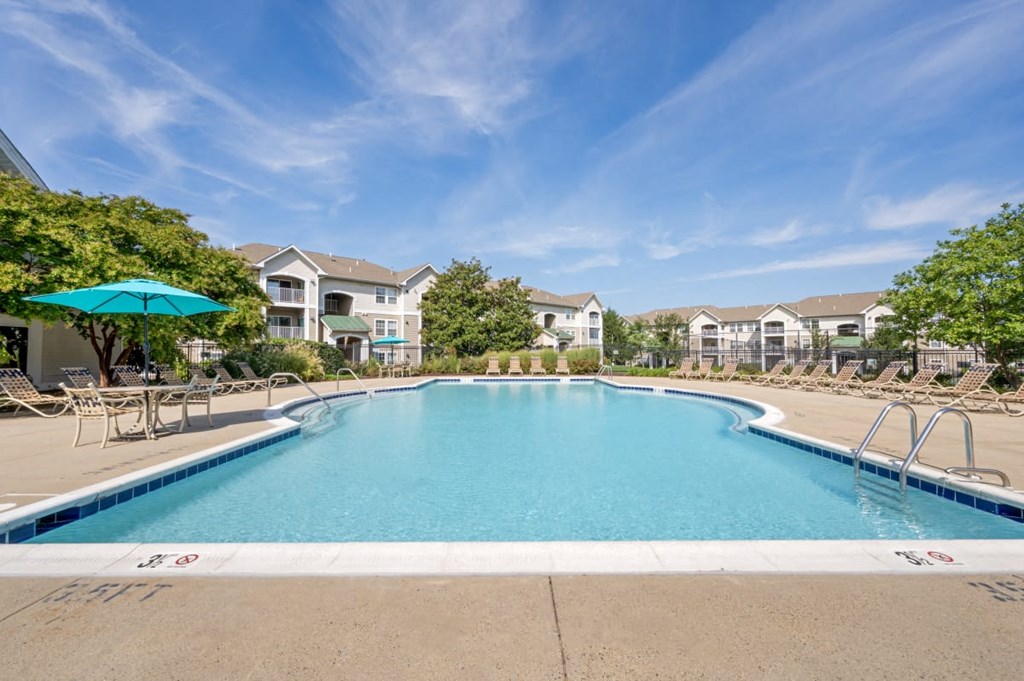 a swimming pool with apartment buildings in the background