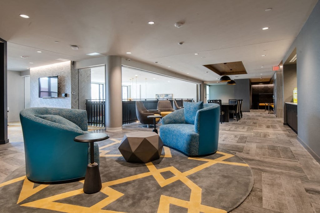 a lobby with couches and tables and chairs