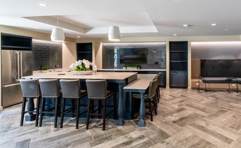 a large kitchen with a large island and chairs