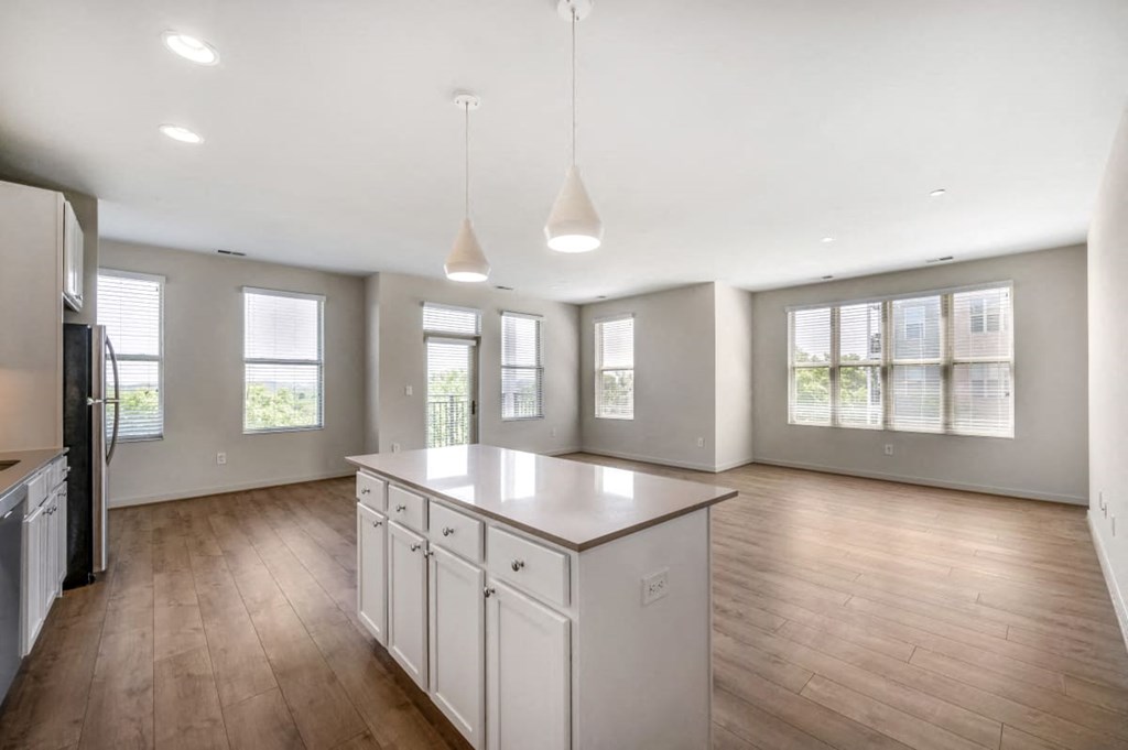 an empty kitchen with an island in the middle of it