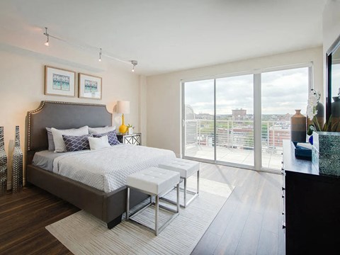 a bedroom with a bed and a large window