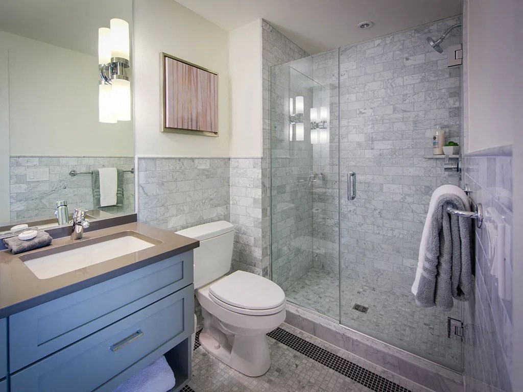 a bathroom with a shower and a sink and a toilet
