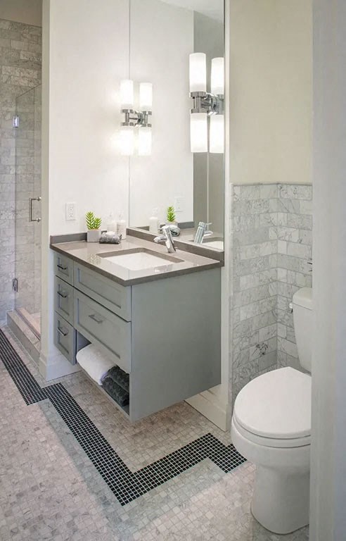 a bathroom with a toilet and a sink and a mirror