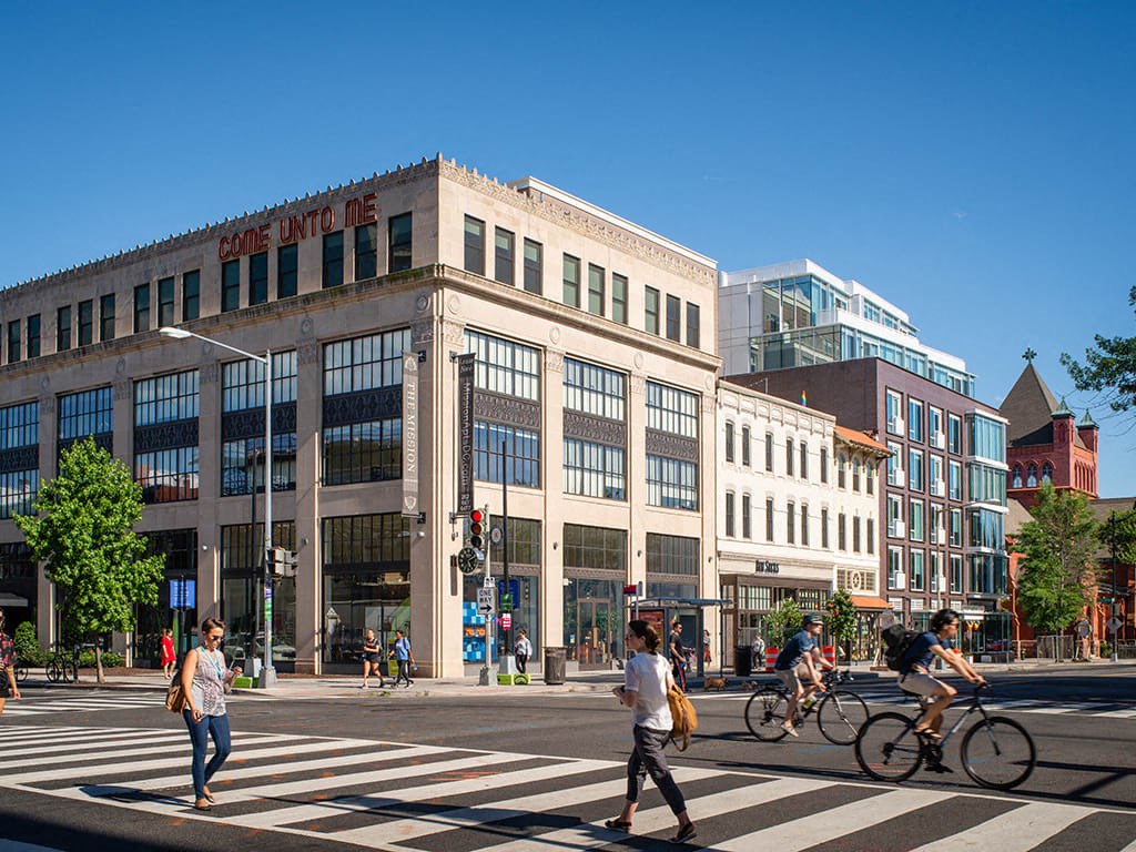people crossing the street in front of a building