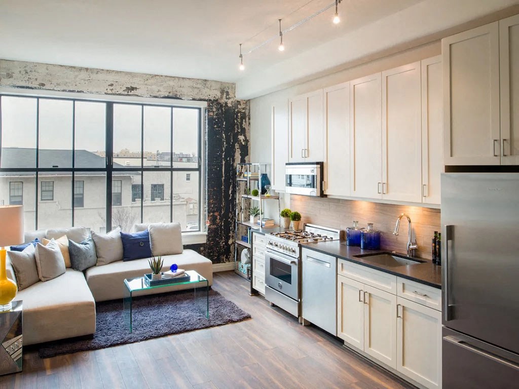 a kitchen and living room with a large window